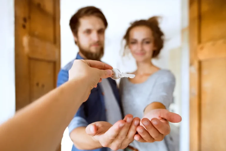 Couple souriant recevant les clés d'un logement