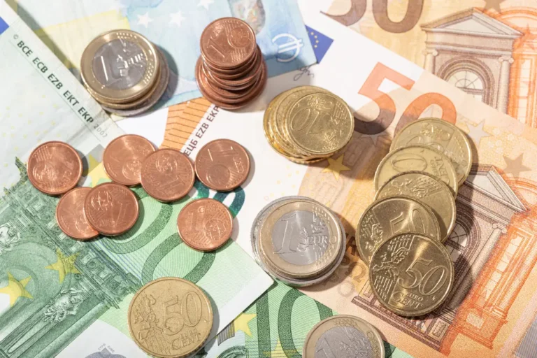 Billets et pièces en euros étalés sur une table, épargne sur livret